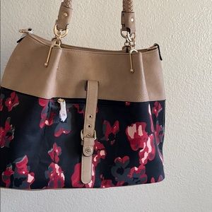 Floral purse with a big makeup bag and a strap.